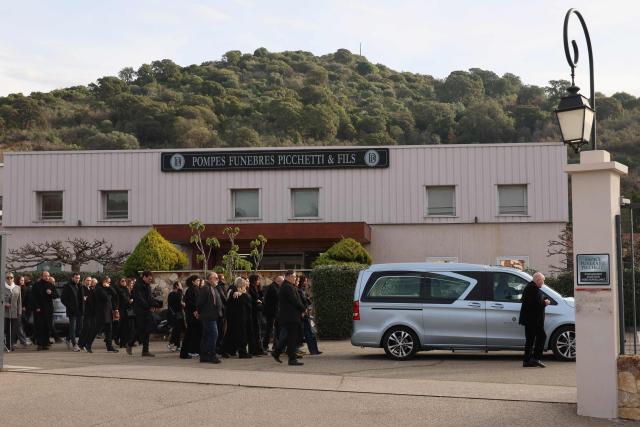 Family members and relatives follow the hearse during the funeral of former Corsican nationalist Alain Orsoni in Ajaccio, on the French Mediterranean Island of Corsica on January 17, 2026. Former Corsican nationalist leader turned businessman and former head of the AC Ajaccio football club, Alain Orsoni, 71, was shot dead on January 12, 2026 while attending his mother's funeral in the small Corsican village of Vero, triggering a new wave of shock across the Island of Corsica, which has been ravaged by internecine conflicts between criminal gangs. (Photo by Pascal POCHARD-CASABIANCA / AFP)