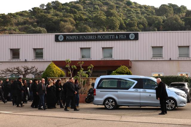 Family members and relatives follow the hearse during the funeral of former Corsican nationalist Alain Orsoni in Ajaccio, on the French Mediterranean Island of Corsica on January 17, 2026. Former Corsican nationalist leader turned businessman and former head of the AC Ajaccio football club, Alain Orsoni, 71, was shot dead on January 12, 2026 while attending his mother's funeral in the small Corsican village of Vero, triggering a new wave of shock across the Island of Corsica, which has been ravaged by internecine conflicts between criminal gangs. (Photo by Pascal POCHARD-CASABIANCA / AFP)