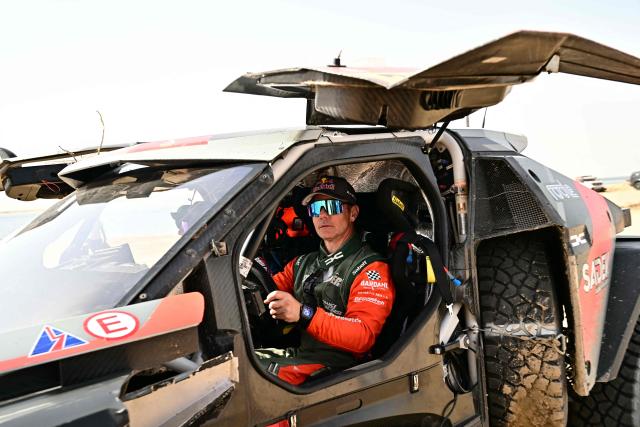 Fourth placed Dacia Sandriders’ French driver Sebastien Loeb sits in his car at the end of the 48th edition of the Dakar Rally 2026 in Yanbu, Saudi Arabia, on January 17, 2026. (Photo by Giuseppe CACACE / AFP)