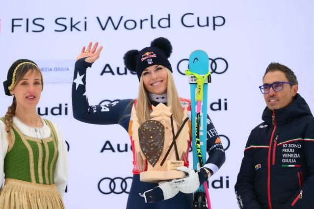 US' Lindsey Vonn, third, celebrates on the podium of the Women's Downhill event of FIS Alpine Skiing World Cup in Tarvisio, Italy on January 17, 2026. Italy's Nicol Delago won the race ahead of Germany's Kira Weidle, second, and US' Lindsey Vonn, third. (Photo by Marco BERTORELLO / AFP)