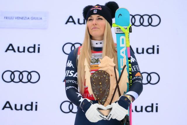 US' Lindsey Vonn, third, celebrates on the podium of the Women's Downhill event of FIS Alpine Skiing World Cup in Tarvisio, Italy on January 17, 2026. Italy's Nicol Delago won the race ahead of Germany's Kira Weidle, second, and US' Lindsey Vonn, third. (Photo by Marco BERTORELLO / AFP)