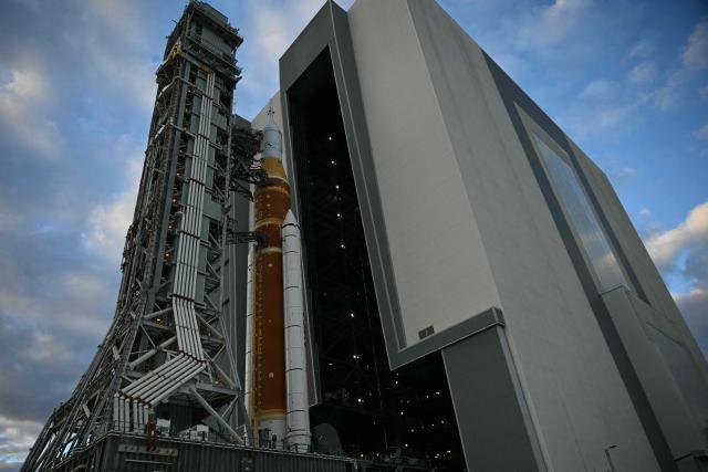 NASA's Artemis II Space Launch System rocket and Orion spacecraft are rolled out of the Vehicle Assembly Building to Launch Pad 39B at Kennedy Space Center in Florida on January 17, 2026, ahead of the crewed lunar mission. (Photo by Jim WATSON / AFP)