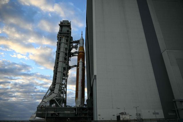 NASA's Artemis II Space Launch System rocket and Orion spacecraft are rolled out of the Vehicle Assembly Building to Launch Pad 39B at Kennedy Space Center in Florida on January 17, 2026, ahead of the crewed lunar mission. (Photo by Jim WATSON / AFP)