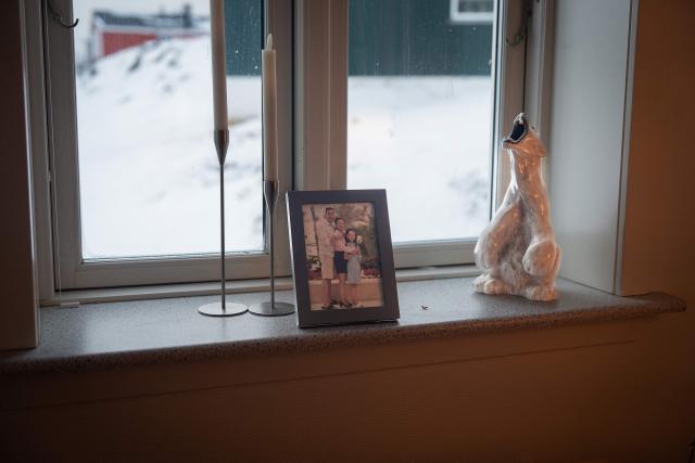 Ornaments including a polarbear and a family photo are on display at Ulrikke Andersen (not in Picture), a 40-year-old tour operator's home in Nuuk, Greenland on January 16, 2026. Ulrikke Andersen says she will plan to leave Greenland in the case of a war or US invasion as US President Donald Trump's designs to take over the Arctic island who no signs of letting up. (Photo by Alessandro RAMPAZZO / AFP)