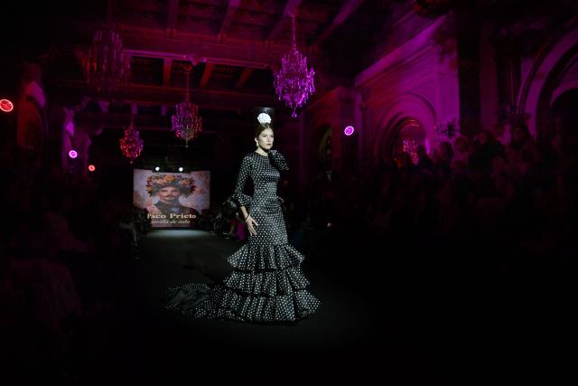 A model showcases a design by Paco Prieto during the XIV edition of the We Love Flamenco fashion show in Seville on January 16, 2026. (Photo by CRISTINA QUICLER / AFP)
