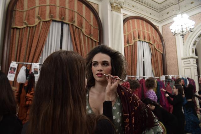 A model gets prepared backstage before designer Rocio Olmedo's show during the XIV edition of the We Love Flamenco fashion show in Seville on January 16, 2026. (Photo by CRISTINA QUICLER / AFP)