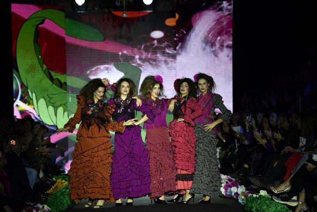 Models showcase designs by Rocio Olmedo during the XIV edition of the We Love Flamenco fashion show in Seville on January 16, 2026. (Photo by CRISTINA QUICLER / AFP)