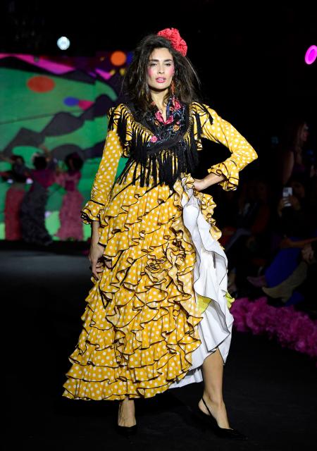 A model showcases a design by Rocio Olmedo during the XIV edition of the We Love Flamenco fashion show in Seville on January 16, 2026. (Photo by CRISTINA QUICLER / AFP)