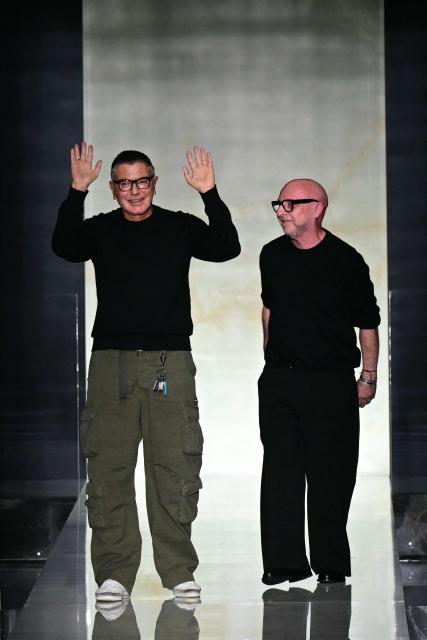 Italian designers Stefano Gabbana and Domenico Dolce (R) greet the audience at the end of the Dolce & Gabbana collection show at Milan's fashion week for the Men's Fall/Winter 2026-2027, on January 17, 2026 in Milan. (Photo by Stefano RELLANDINI / AFP)