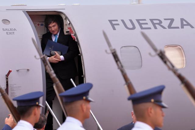 Argentina's President Javier Milei arrives at Silvio Pettirossi International Airport in Luque, Paraguay, for the signing ceremony of the agreement between the European Union and Mercosur, on January 17, 2026. The South American bloc Mercosur and the European Union will sign a deal on January 17, 25 years in the making, to create one of the world's biggest free trade areas at a time of growing protectionism and volatility. (Photo by Daniel Duarte / AFP)