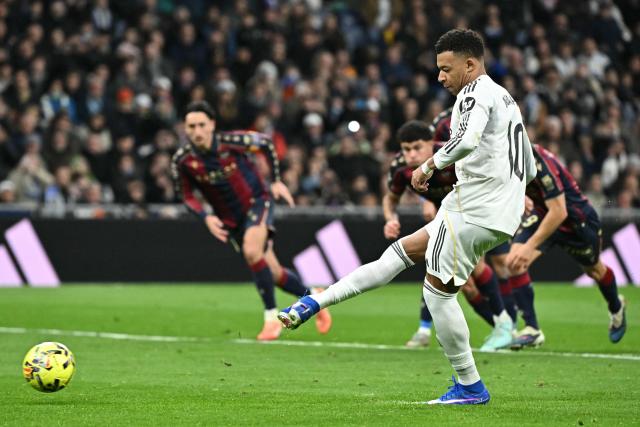 Real Madrid's French forward #10 Kylian Mbappe scores the opening goal from the penalty spot during the Spanish league football match between Real Madrid CF and Levante UD at Santiago Bernabeu Stadium in Madrid on January 17, 2026. (Photo by Javier SORIANO / AFP)
