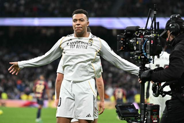 Real Madrid's French forward #10 Kylian Mbappe celebrates scoring the opening goal during the Spanish league football match between Real Madrid CF and Levante UD at Santiago Bernabeu Stadium in Madrid on January 17, 2026. (Photo by Javier SORIANO / AFP)