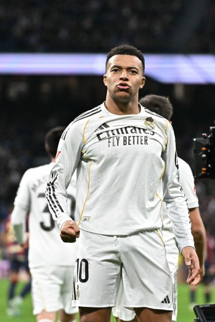 Real Madrid's French forward #10 Kylian Mbappe celebrates scoring the opening goal during the Spanish league football match between Real Madrid CF and Levante UD at Santiago Bernabeu Stadium in Madrid on January 17, 2026. (Photo by Javier SORIANO / AFP)
