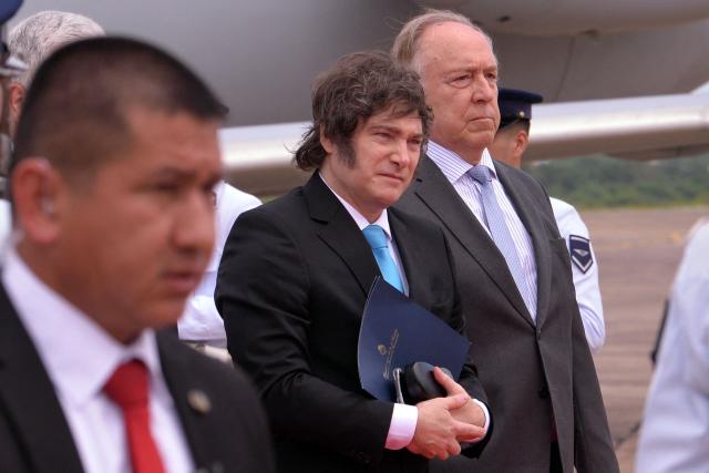 Argentina's President Javier Milei arrives at Silvio Pettirossi International Airport in Luque, Paraguay, for the signing ceremony of the agreement between the European Union and Mercosur, on January 17, 2026. The South American bloc Mercosur and the European Union will sign a deal on January 17, 25 years in the making, to create one of the world's biggest free trade areas at a time of growing protectionism and volatility. (Photo by Daniel Duarte / AFP)