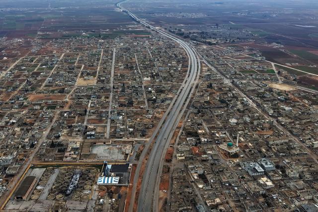 An aerial view shows the Raqqa district,  where Syrian Ministry of Defense special forces have entered and the Kurdish forces have withdrawn from the key towns of Deir Hafer and Maskana, as well as a military airport, in northern Syria on January 17, 2026. Syria's army said January 17, that its forces had taken control of swathes of the region east of Aleppo city after Kurdish forces agreed to withdraw following recent clashes. (Photo by Bakr ALkasem / AFP)