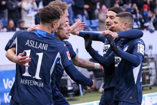 Hoffenheim's Dutch midfielder #18 Wouter Burger (2nd L) celebrates scoring the opening goal with his teammates during the German first division Bundesliga football match between TSG 1899 Hoffenheim and FC Bayern Munich in Sinsheim, southwestern Germany on January 17, 2026. (Photo by Daniel ROLAND / AFP) / DFL REGULATIONS PROHIBIT ANY USE OF PHOTOGRAPHS AS IMAGE SEQUENCES AND/OR QUASI-VIDEO