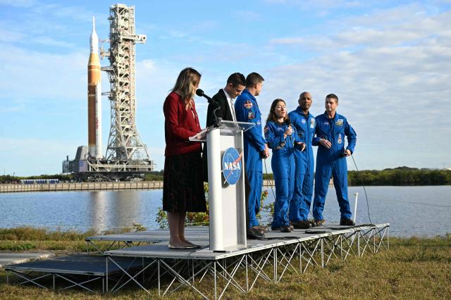 Artemis II mission's specialists Christina Koch, speaks next to mission Commander Reid Wiseman pilot Victor Glover, Jeremy Hansen and NASA Administrator Jared Isaacmanduring the rollout of NASA's next-generation moon rocket, the Space Launch System (SLS) rocket with the Orion crew capsule, to the launch pad at the Kennedy Space Center in Cape Canaveral, Florida, U.S., January 17, 2026. Launch around the moon and back is scheduled for no earlier than February 6, 2026. (Photo by Jim WATSON / AFP)