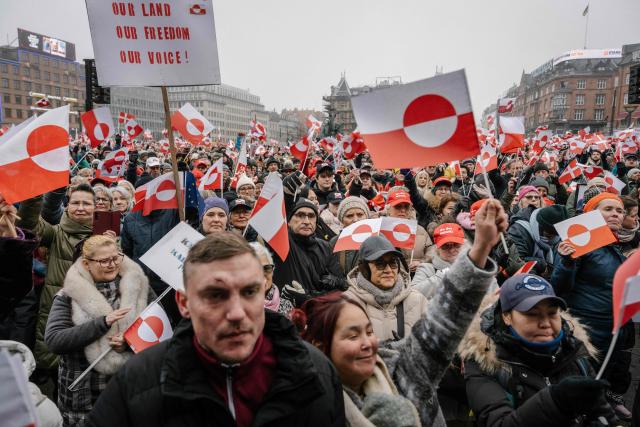Protesters wave Greenlandic flags as they take part in a rally under the slogans 'hands off Greenland' and 'Greenland for Greenlanders', in front of City Hall in Copenhagen, Denmark on January 17, 2026. (Photo by Emil Nicolai Helms / Ritzau Scanpix / AFP) / Denmark OUT