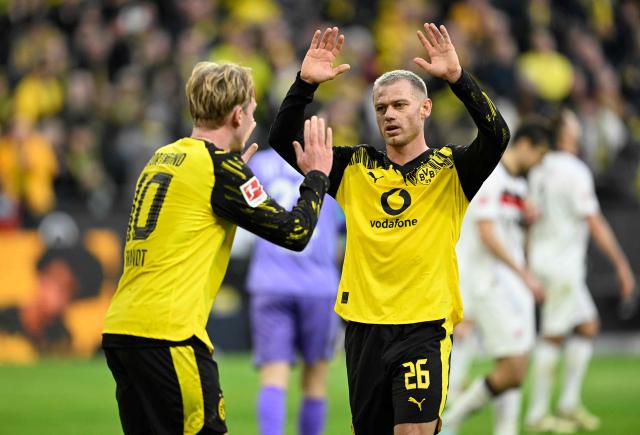 Dortmund's German midfielder #10 Julian Brandt (L) celebrates with Dortmund's Norwegian defender #26 Julian Ryerson after scoring the 1-0 goal during the German first division Bundesliga football match between BVB Borussia Dortmund and FC St Pauli in Dortmund, western Germany, on January 17, 2026. (Photo by INA FASSBENDER / AFP) / DFL REGULATIONS PROHIBIT ANY USE OF PHOTOGRAPHS AS IMAGE SEQUENCES AND/OR QUASI-VIDEO