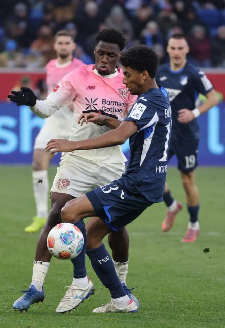 Bayer Leverkusen's Dutch forward #19 Ernest Poku (L) and Hoffenheim's Brazilian defender #13 Bernardo vie for the ball during the German first division Bundesliga football match between TSG 1899 Hoffenheim and FC Bayern Munich in Sinsheim, southwestern Germany on January 17, 2026. (Photo by Daniel ROLAND / AFP) / DFL REGULATIONS PROHIBIT ANY USE OF PHOTOGRAPHS AS IMAGE SEQUENCES AND/OR QUASI-VIDEO