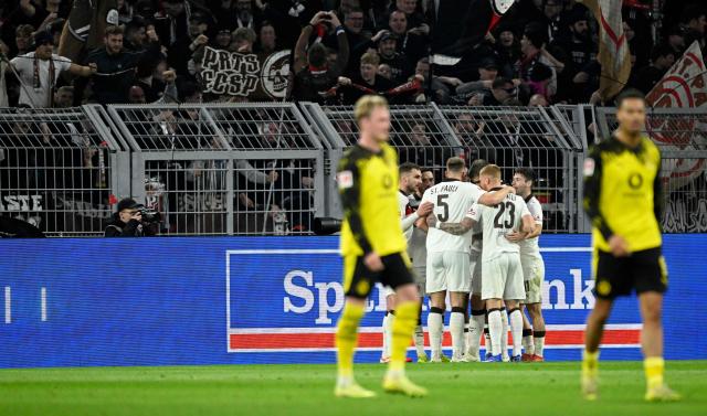 St Pauli's players celebrate after scoring the 2-2 goal during the German first division Bundesliga football match between BVB Borussia Dortmund and FC St Pauli in Dortmund, western Germany, on January 17, 2026. (Photo by INA FASSBENDER / AFP) / DFL REGULATIONS PROHIBIT ANY USE OF PHOTOGRAPHS AS IMAGE SEQUENCES AND/OR QUASI-VIDEO