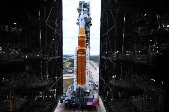 NASA's Artemis II Space Launch System rocket and Orion spacecraft are rolled out of the Vehicle Assembly Building to Launch Pad 39B at Kennedy Space Center in Florida on January 17, 2026, ahead of the crewed lunar mission. (Photo by Jim WATSON / AFP)