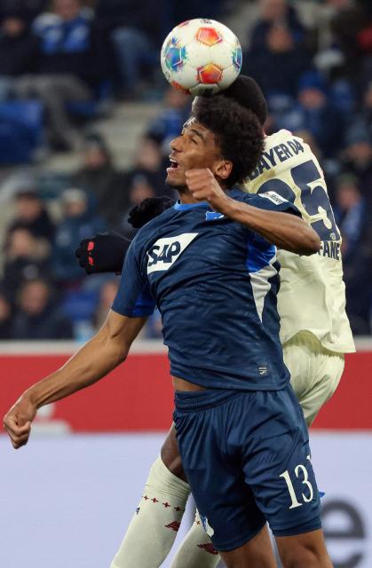 Hoffenheim's Brazilian defender #13 Bernardo (L) and Bayer Leverkusen's Cameroonian forward #35 Christian Kofane both jump to head the ball during the German first division Bundesliga football match between TSG 1899 Hoffenheim and FC Bayern Munich in Sinsheim, southwestern Germany on January 17, 2026. (Photo by Daniel ROLAND / AFP) / DFL REGULATIONS PROHIBIT ANY USE OF PHOTOGRAPHS AS IMAGE SEQUENCES AND/OR QUASI-VIDEO