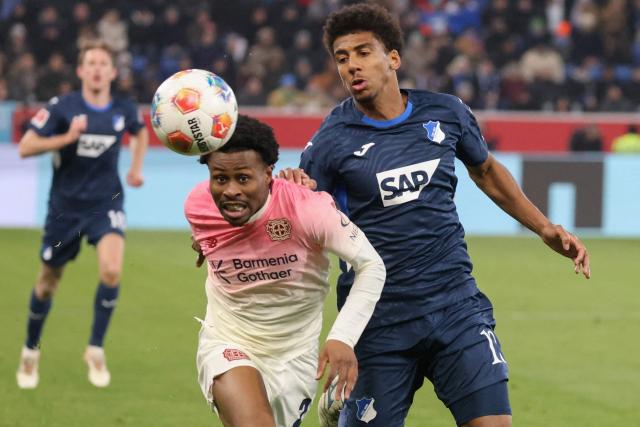 Hoffenheim's Brazilian defender #13 Bernardo (R) and Bayer Leverkusen's English forward #23 Nathan Tella vie for the ball during the German first division Bundesliga football match between TSG 1899 Hoffenheim and FC Bayern Munich in Sinsheim, southwestern Germany on January 17, 2026. (Photo by Daniel ROLAND / AFP) / DFL REGULATIONS PROHIBIT ANY USE OF PHOTOGRAPHS AS IMAGE SEQUENCES AND/OR QUASI-VIDEO  ALTERNATIVE CROP