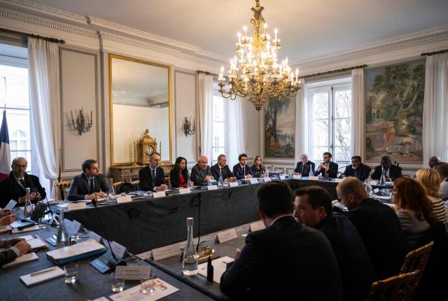 France's Overseas Minister Naima Moutchou (4th-L) takes part in a meeting with a delegation of representatives of New-Caledonia at France's Overseas Ministry in Paris on January 17, 2026. On January 16, France's President opened a new round of discussions on the institutional future of New Caledonia, stating his desire to move forward “without forcing the issue but without paralysis,” despite the absence of the main independence movement. (Photo by Martin LELIEVRE / AFP)