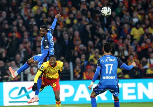 Auxerre's French defender #38 Alvin Petit Dol (R) and Auxerre's Malian forward #10 Lassine Sinayoko (L) fight for the ball with Lens' French forward #38 Rayan Fofana (2ndL) during the French L1 football match between RC Lens and AJ Auxerre at the Stade Bollaert-Delelis in Lens, northern France, on January 17, 2026. (Photo by Francois LO PRESTI / AFP)