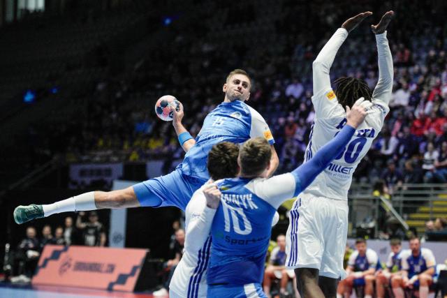 Ukraine's center back #15 Oleksandr Tilte (L) shoots the ball during the EHF Euro 2026 group C preliminary round handball match between Ukraine and France in Baerum near Oslo, Norway, on January 17, 2026. (Photo by Stian Lysberg Solum / NTB / AFP) / Norway OUT