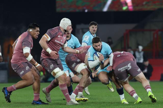 Castres' French scrum-half Jeremy Fernandez (2R) is tackled during the European Champions Cup pool 2 rugby union match between Munster and Castres Olympique at Thomond Park in Limerick, Ireland on January 17, 2026. (Photo by LORRAINE O'SULLIVAN / AFP)