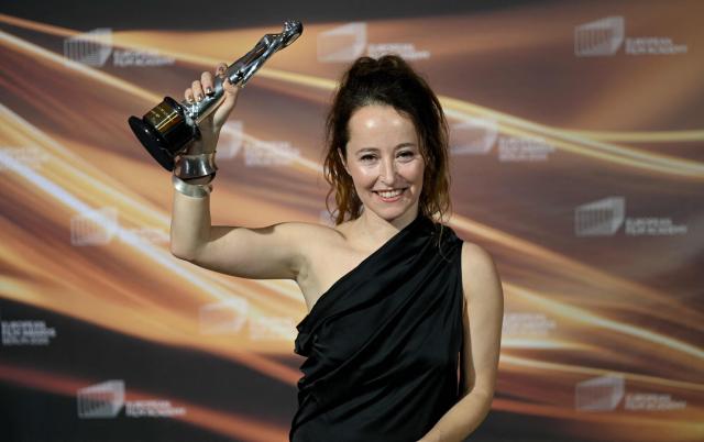 Spanish art director Laia Ateca holds up her "European Production Designer" trophy she was given for the movie "Sirat" during the European Film Awards on January 17, 2026 in Berlin. (Photo by RALF HIRSCHBERGER / AFP)