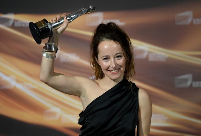 Spanish art director Laia Ateca holds up her "European Production Designer" trophy she was given for the movie "Sirat" during the European Film Awards on January 17, 2026 in Berlin. (Photo by RALF HIRSCHBERGER / AFP)