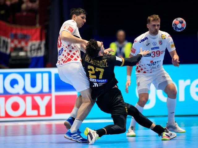 Croatia's left back #30 Marko Mamic (L) and Georgia's left back #27 Nikoloz Kalandadze collide during the EHF Euro 2026 group E preliminary round handball match between Croatia and Georgia in Malmo, Sweden, on January 17, 2026. (Photo by Andreas Hillergren/TT / TT News Agency / AFP) / Sweden OUT