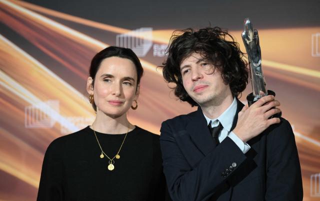 Winners of the European Animated Feature Film Award, French film producer Sophie Mas (L) and French director and illustrator Ugo Bienvenu, celebrate with the trophy during the European Film Awards ceremony on January 17, 2026 in Berlin. (Photo by RALF HIRSCHBERGER / AFP)