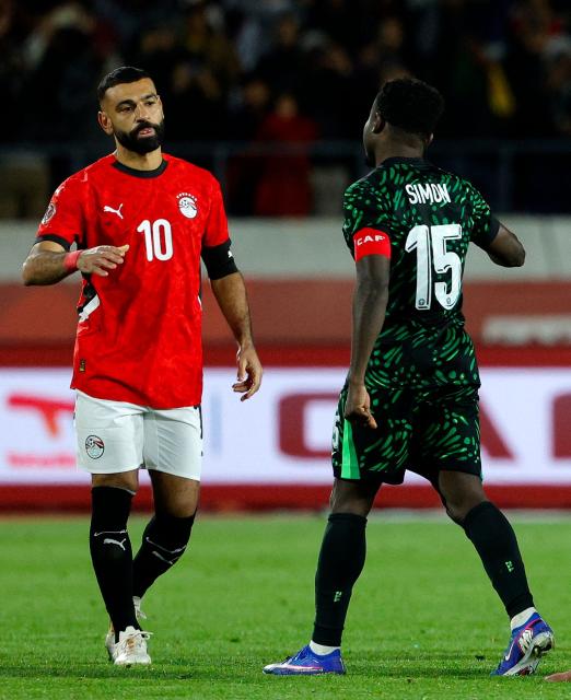 Egypt's forward #10 Mohamed Salah reacts with Nigeria's forward #15 Moses Simon after the Africa Cup of Nations (CAN) third place football match between Egypt and Nigeria at the Mohammed V Stadium in Casablanca on January 17, 2026. (Photo by Abdel Majid BZIOUAT / AFP)