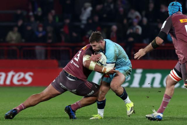 Castres' French scrum-half Jeremy Fernandez is tackled by Munster's Samoan prop Michael Ala'alatoa during the European Champions Cup pool 2 rugby union match between Munster and Castres Olympique at Thomond Park in Limerick, Ireland on January 17, 2026. (Photo by LORRAINE O'SULLIVAN / AFP)