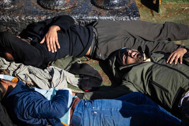 Migrants suffering from severe dehydration and seasickness lie on the floor onboard the Sider, a merchant ship, in the search-and-rescue zone in international waters off the coast of Libya, on January 17, 2026. Crew members of the Ocean Viking rescue ship evacuated 44 migrants who had been rescued by a merchant ship a few days earlier in Libyas search-and-rescue zone in international waters. They were suffering from severe dehydration, seasickness, and a lack of medical care. Some were unable to walk and had to be evacuated on stretchers. They had left Libya a couple of days earlier aboard a fiberglass boat, hoping to reach the Italian coast before being shipwrecked in rough seas and rescued by a Tanzanian-flagged merchant ship. (Photo by Sameer Al-DOUMY / AFP)