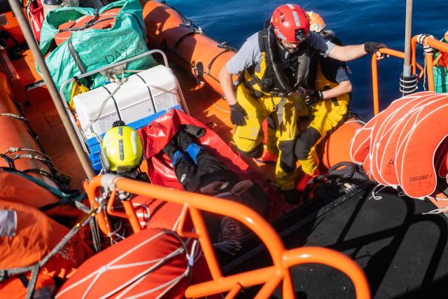 Crew members of the "Ocean Viking" rescue ship evacuates a migrant suffering from severe dehydration and seasickness, on a soft stretcher from the Sider, a merchant ship, using a RHIB (Rigid inflatable boat), in the search-and-rescue zone in international waters off the coast of Libya, on January 17, 2026. Crew members of the Ocean Viking rescue ship evacuated 44 migrants who had been rescued by a merchant ship a few days earlier in Libyas search-and-rescue zone in international waters. They were suffering from severe dehydration, seasickness, and a lack of medical care. Some were unable to walk and had to be evacuated on stretchers. They had left Libya a couple of days earlier aboard a fiberglass boat, hoping to reach the Italian coast before being shipwrecked in rough seas and rescued by a Tanzanian-flagged merchant ship. (Photo by Sameer Al-DOUMY / AFP)