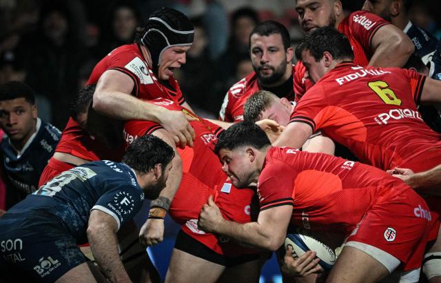TOPSHOT - Toulouse's French hooker Julien Marchand (C) holds the ball during a scrum during the European Champions Cup pool 1, round 4, rugby union match between Stade Toulousain Rugby (Toulouse) and Sale Sharks at the Ernest Wallon Stadium in Toulouse, southwestern France, on January 17, 2026. (Photo by Lionel BONAVENTURE / AFP)