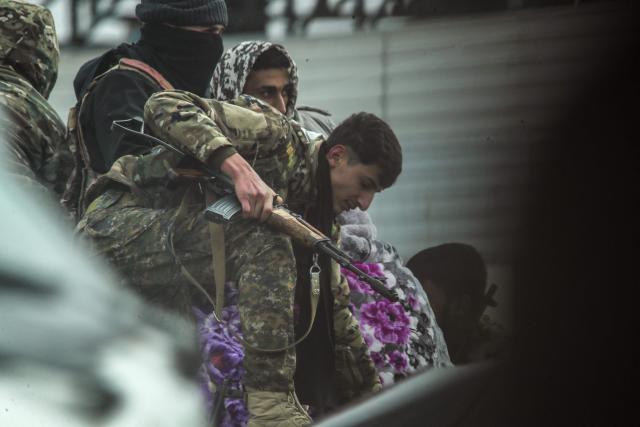 Kurdish forces are seen at the entrance to the city of Tabqa after withdrawing from the towns in the area, in the northern Syrian Raqa province, on January 17, 2026. Syria's army took control of swathes of northern Syria and threatened to bomb parts of Raqa province on January 17, after Kurdish forces pulled back from territory they had held for over a decade. The Syrian army said it had begun entering the city of Tabqa in Raqa province, adding that it was "encircling" the Kurdish forces at their military airport. (Photo by Delil SOULEIMAN / AFP)