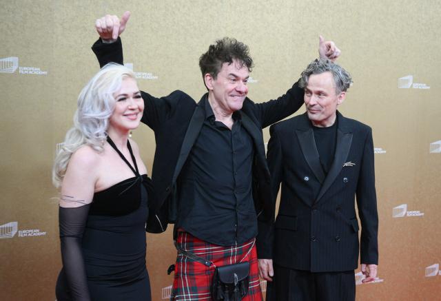 German composer and Music Director Dascha Dauenbauer, Northern Irish director and writer Mark Cousins and German film director and Stage Director Robert Lehniger arrive for the European Film Awards ceremony on January 17, 2026 in Berlin. (Photo by RALF HIRSCHBERGER / AFP)