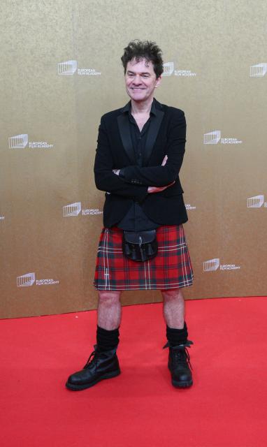 Northern Irish director and writer Mark Cousins arrives for the European Film Awards ceremony on January 17, 2026 in Berlin. (Photo by RALF HIRSCHBERGER / AFP)