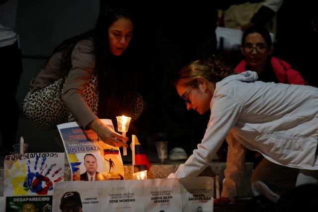 People put candles during a vigil to demand the freedom of political prisoners allegedly held in El Helicoide prison in Caracas on January 17, 2026. (Photo by Pedro MATTEY / AFP)