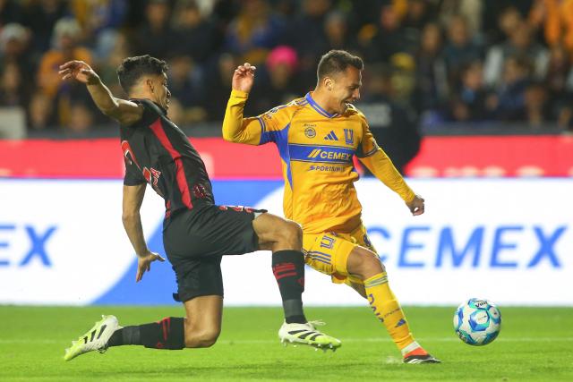 Toluca's defender #02 Diego Barbosa (L) and Tigres' defender #35 Osvaldo Rodriguez (R) fight for the ball during the Liga MX Clausura football match between Tigres and Toluca at the University Stadium (UANL) in San Nicolas de los Garza, Mexico on January 17, 2026. (Photo by Julio Cesar AGUILAR / AFP)