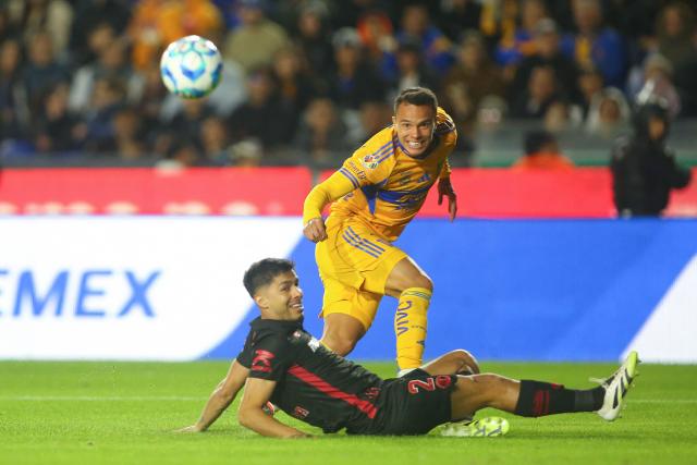Tigres' defender #35 Osvaldo Rodriguez (top) looks at the ball past Toluca's defender #02 Diego Barbosa (bottom) during the Liga MX Clausura football match between Tigres and Toluca at the University Stadium (UANL) in San Nicolas de los Garza, Mexico on January 17, 2026. (Photo by Julio Cesar AGUILAR / AFP)