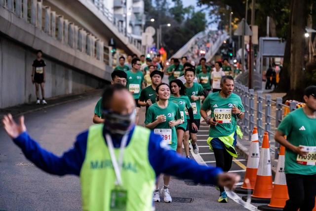 Runners take part in the 10km race during the Hong Kong Marathon in Hong Kong on January 18, 2026. (Photo by ISAAC LAWRENCE / AFP)