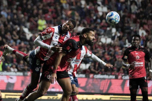 San Luis' defender #03 Robson Bambu (L) and Tijuana's Spanish forward #09 Mourad El Ghezouani (R) fight for the ball during the Liga MX Clausura football match between Tijuana and Atletico de San Luis at the Caliente Stadium in Tijuana, Baja California, Mexico on January 17, 2026. (Photo by Guillermo ARIAS / AFP)