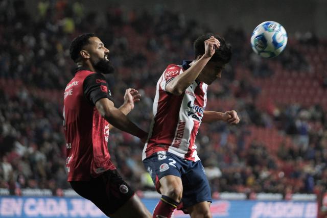 Tijuana's Spanish forward #09 Mourad El Ghezouani (L) and San Luis' defender #02 Roman Torres (R) fight for the ball during the Liga MX Clausura football match between Tijuana and Atletico de San Luis at the Caliente Stadium in Tijuana, Baja California, Mexico on January 17, 2026. (Photo by Guillermo ARIAS / AFP)